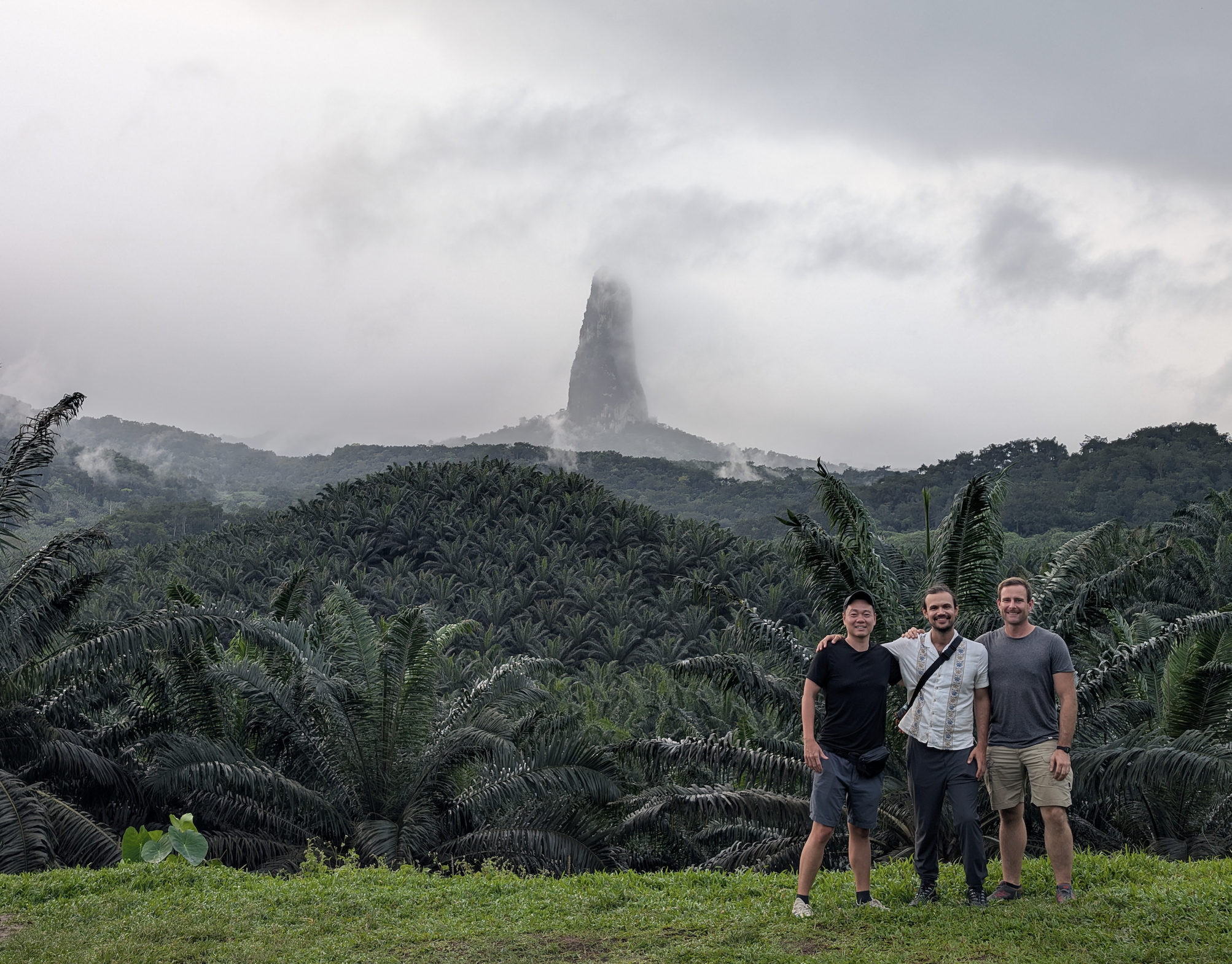 Three friends in front of Pico Cão Grande, São Tomé